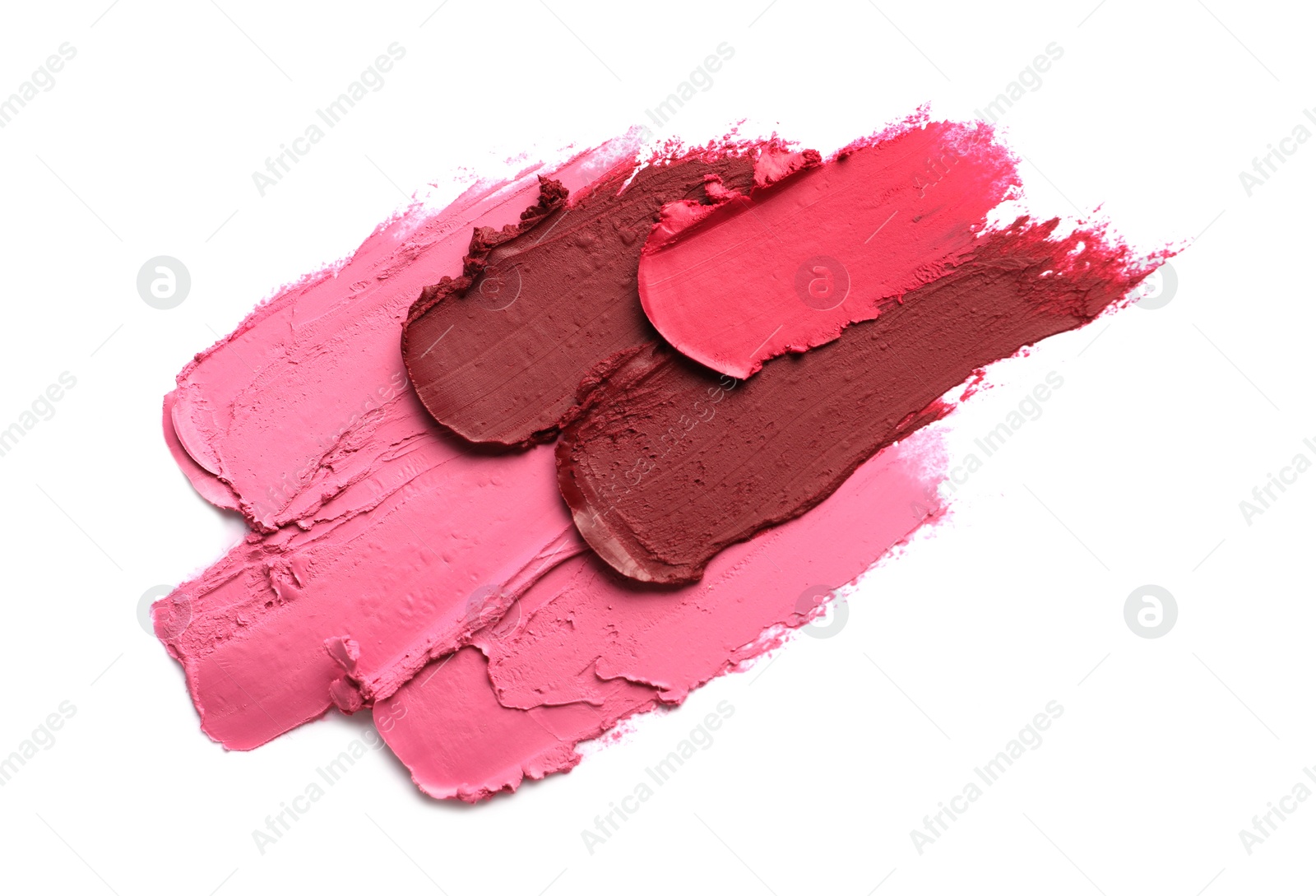 Photo of Smears of bright lipsticks on white background, top view