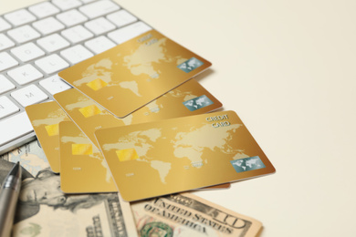 Photo of Credit cards, computer keyboard and money on light background