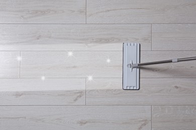 Image of Washing floor with mop indoors, top view. Clean and shiny trace on dirty surface