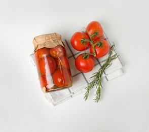 Photo of Flat lay composition with pickled tomatoes in glass jar on white table
