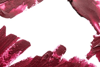 Lipstick smears on white background, top view. Space for text