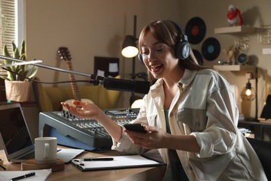 Photo of Woman working as radio host in modern studio