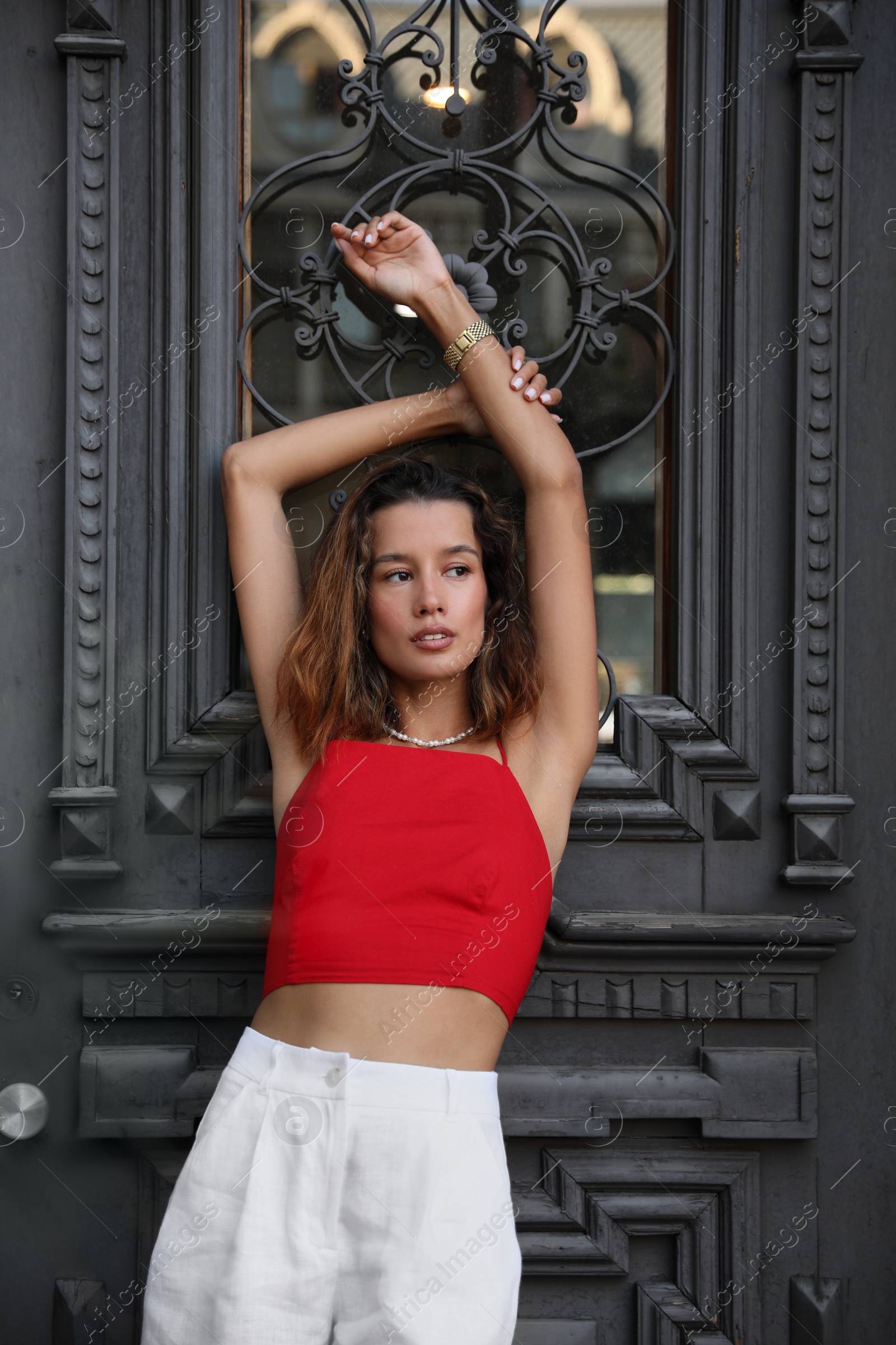 Photo of Portrait of beautiful young woman near vintage door outdoors