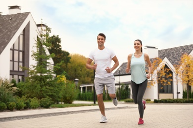 Photo of Sporty couple running on street. Healthy lifestyle