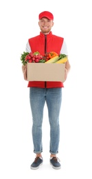 Photo of Delivery man with box of fresh vegetables on white background