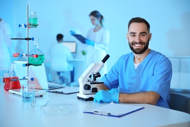 Portrait of medical student working in scientific laboratory. Space for text