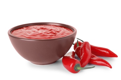 Photo of Bowl with red sauce and fresh chili peppers isolated on white