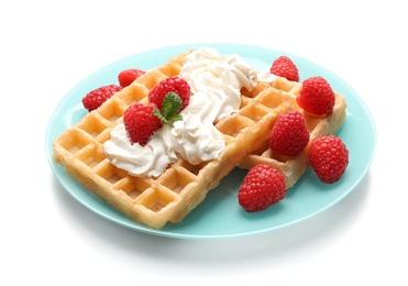 Photo of Plate with yummy waffles, whipped cream and raspberries on white background