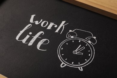 Drawing of alarm clock and words Life, Work on blackboard, closeup. Balance concept