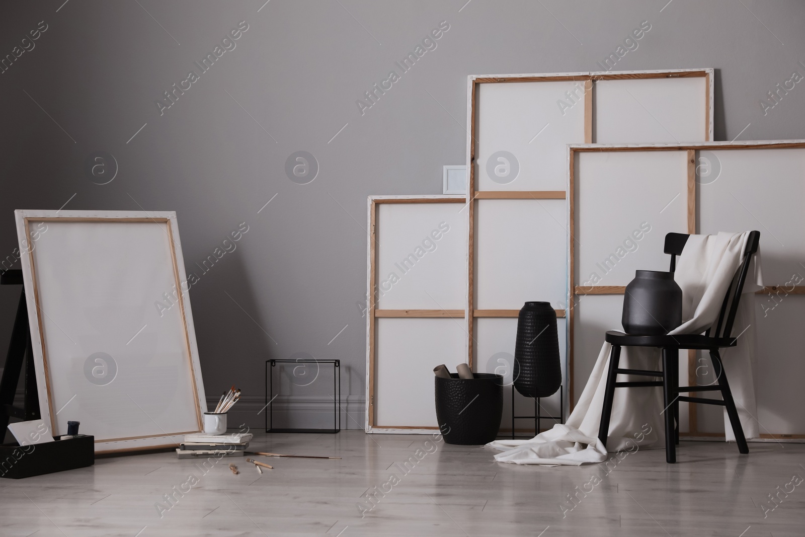 Photo of Stylish artist's studio interior with canvas and brushes