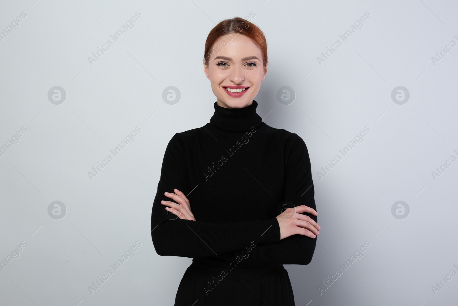 Photo of Portrait of beautiful young woman on light gray background