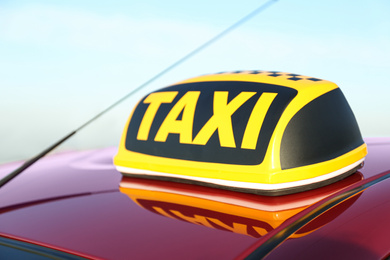 Photo of Roof light with word TAXI on car outdoors