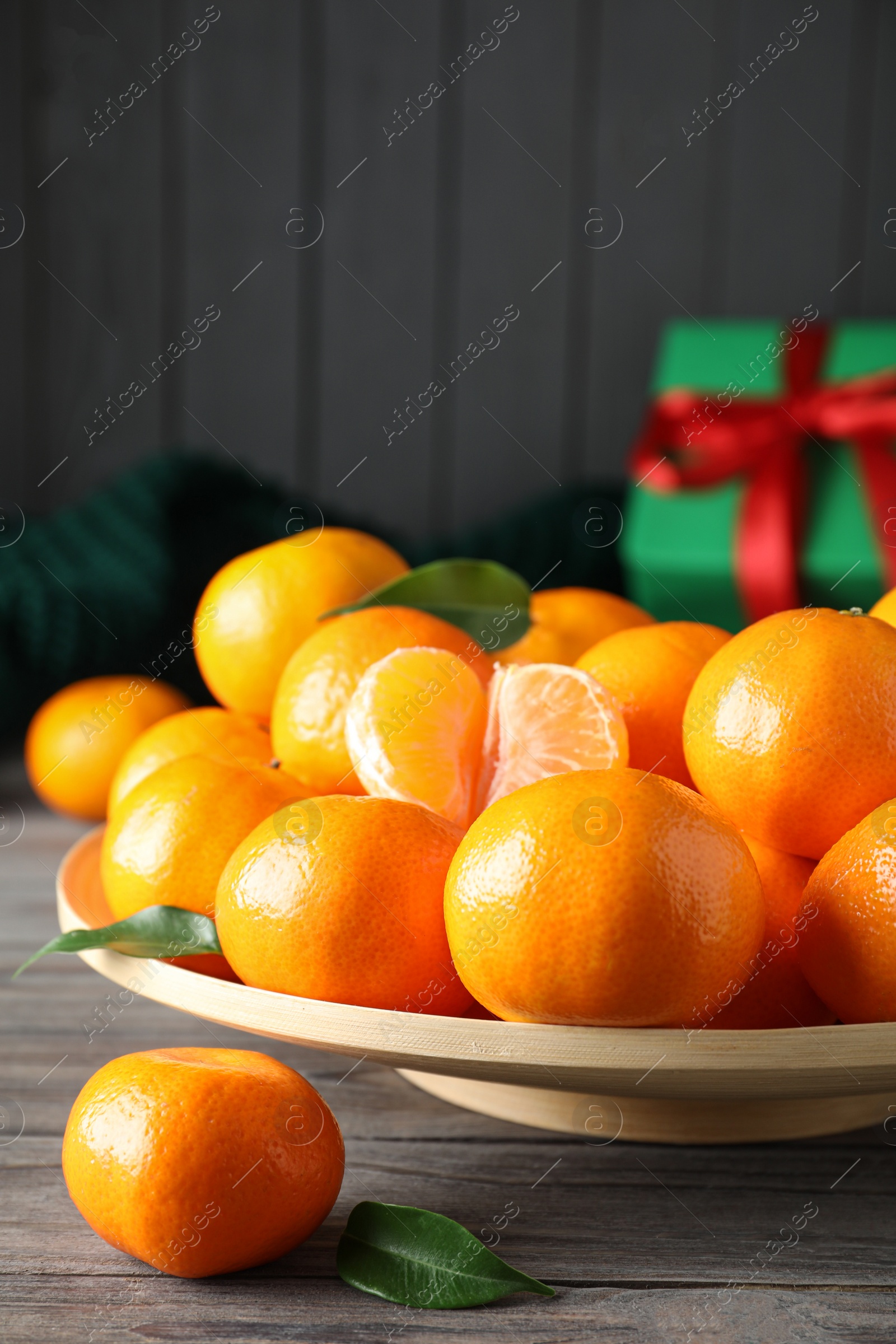 Photo of Tasty fresh tangerines on wooden table. Christmas celebration