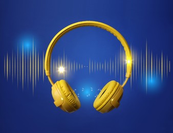 Image of Modern yellow headphones and illustration of dynamic sound waves on blue background
