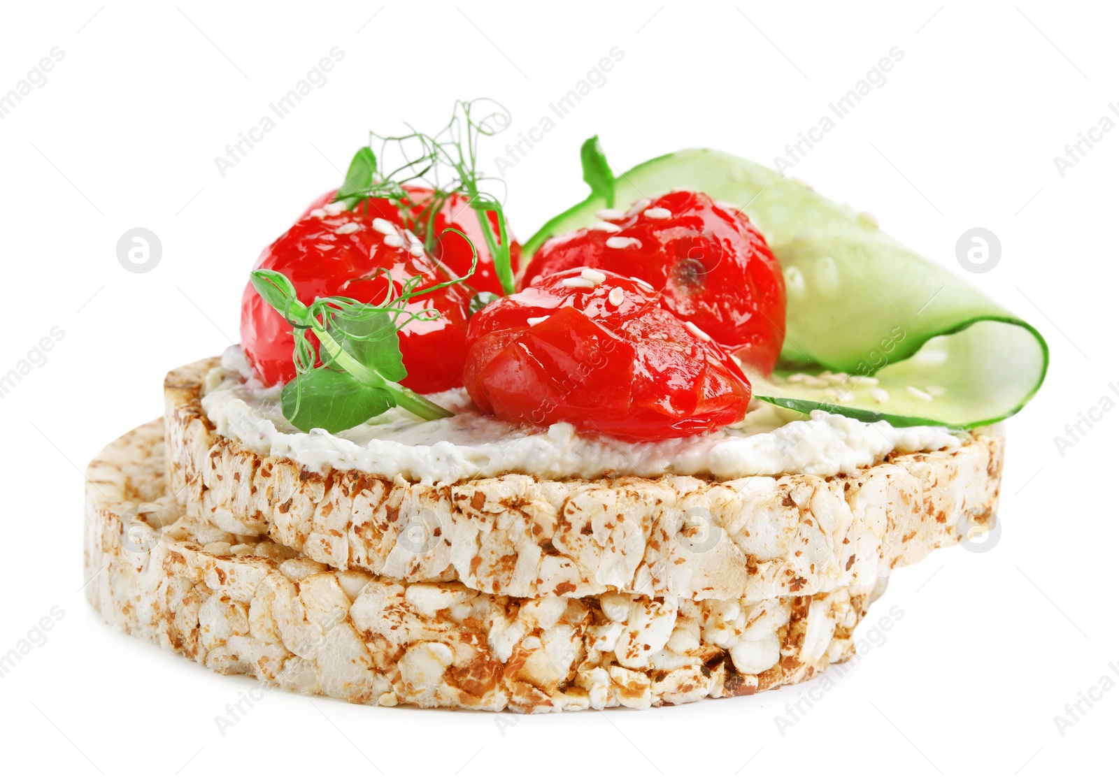 Photo of Crunchy buckwheat cakes with cream cheese, tomatoes and cucumber slice isolated on white
