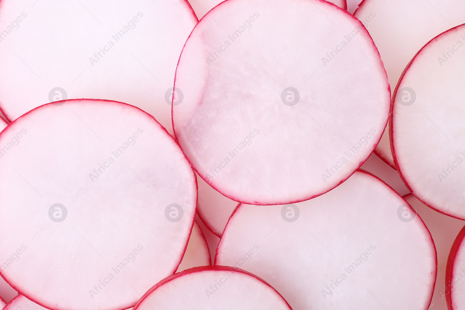 Photo of Slices of fresh ripe radish as background, top view