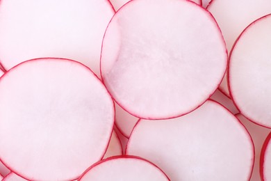 Slices of fresh ripe radish as background, top view