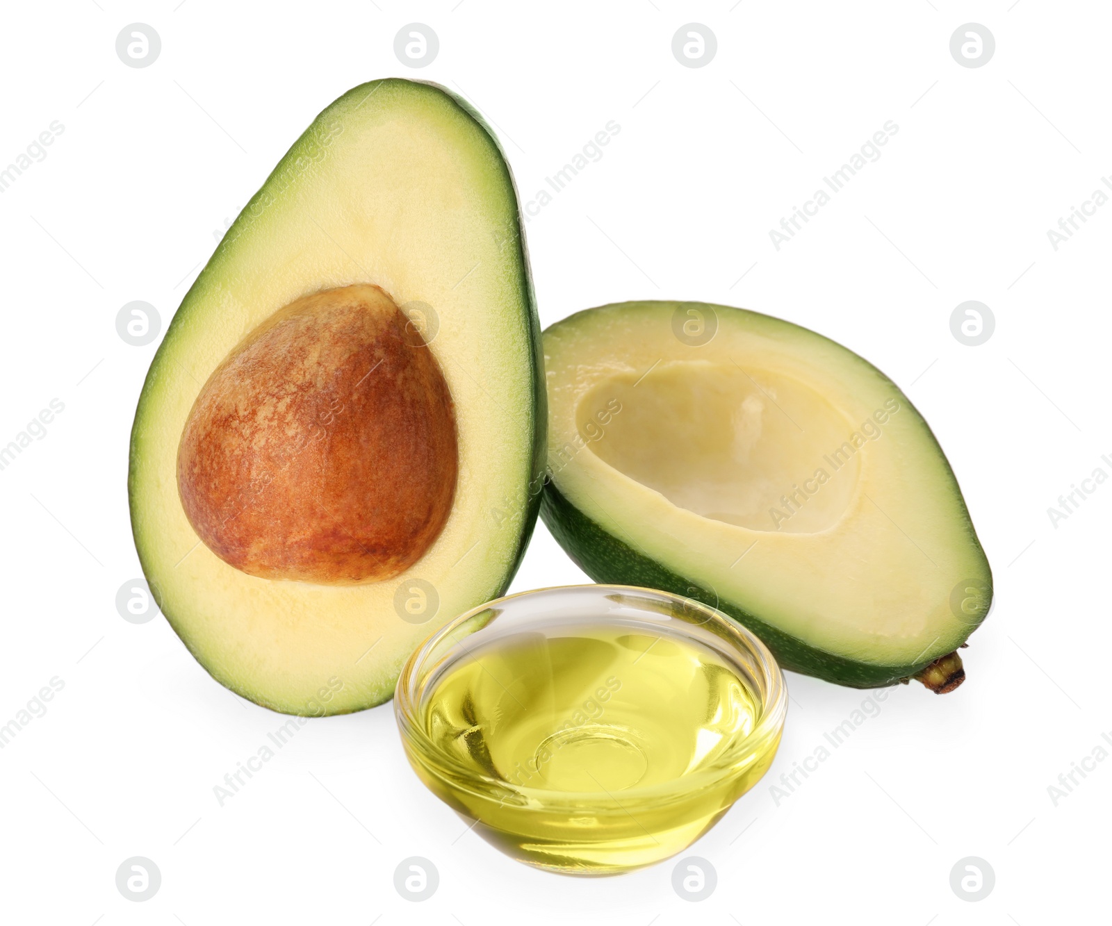 Photo of Cooking oil and fresh avocado halves isolated on white