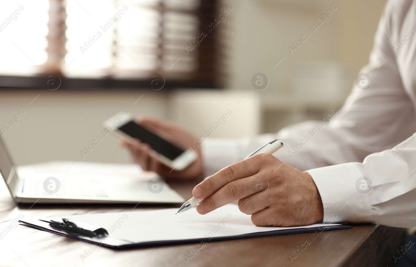 Photo of Business trainer working at table in office, closeup