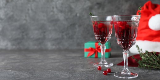 Image of Delicious Christmas cocktail with liqueur on grey table, space for text. Banner design