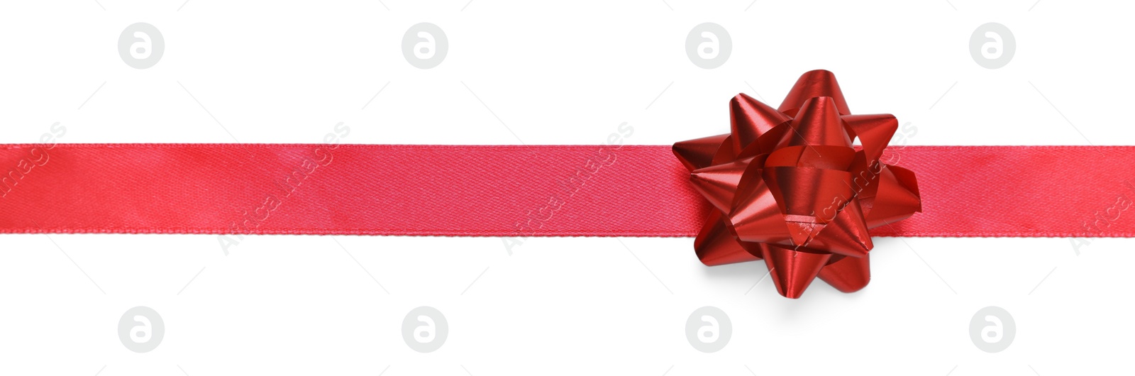 Photo of Red ribbon with bow on white background, top view