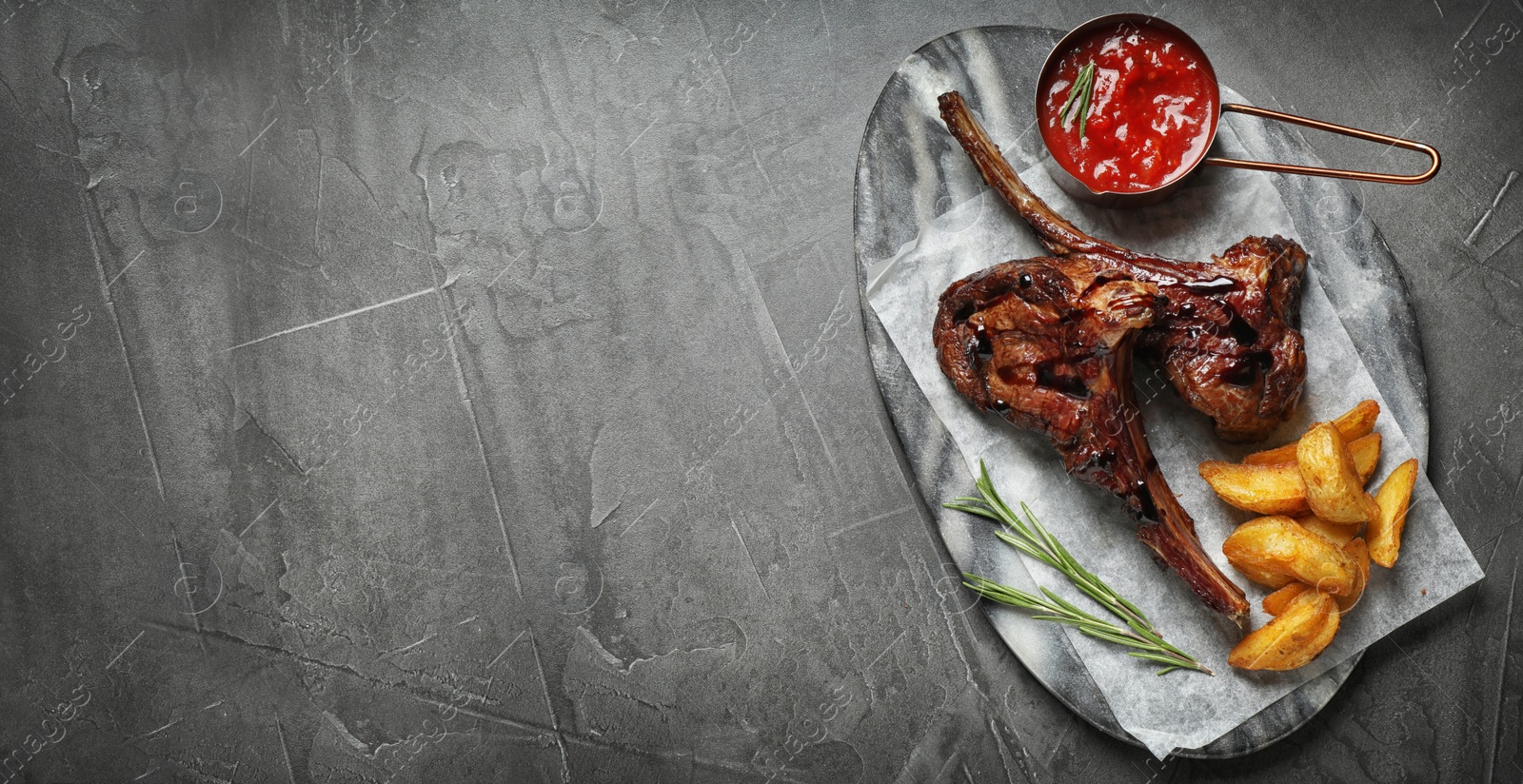 Image of Plate with delicious grilled ribs and space for text on grey table, top view. Banner design