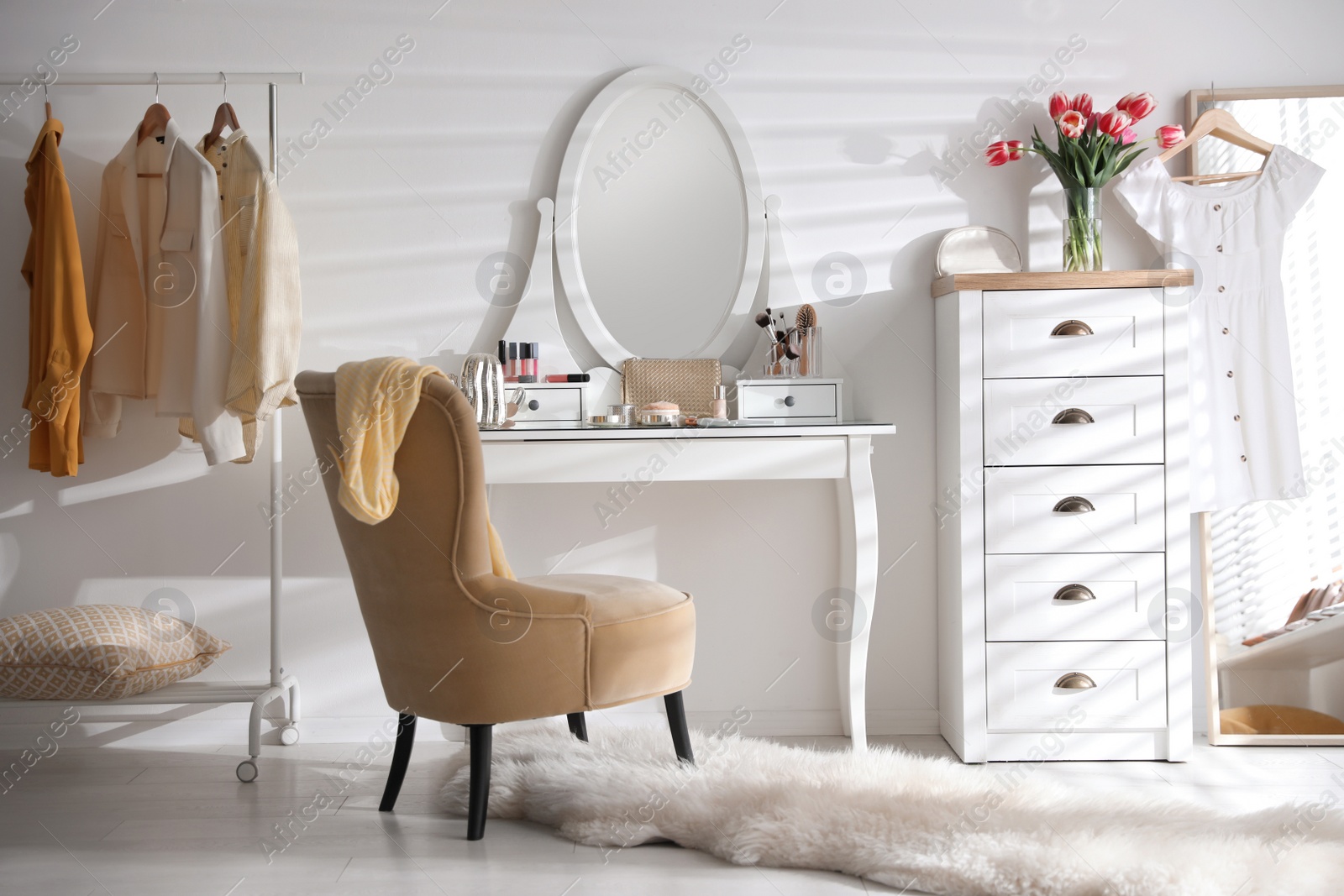 Photo of Stylish room interior with elegant dressing table, mirror and comfortable chair