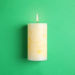 Photo of Alight scented wax candle on color background