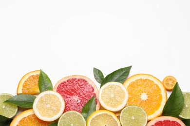 Photo of Fresh juicy citrus fruits with green leaves on white background, flat lay. Space for text