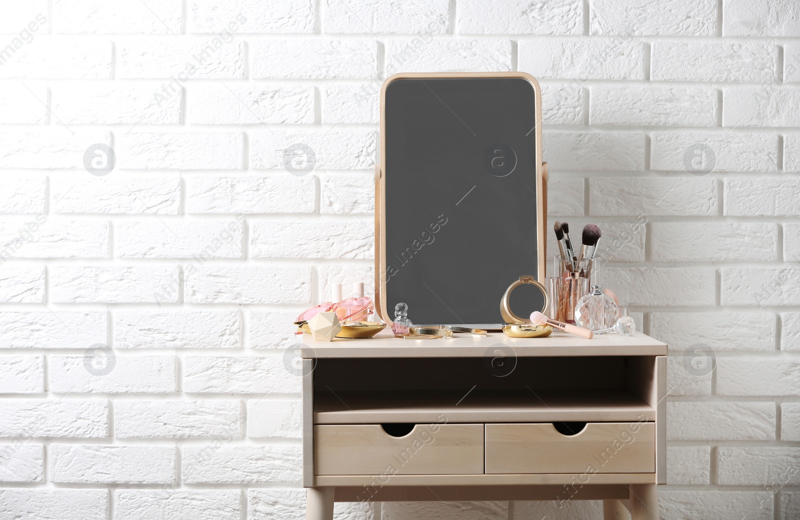 Photo of Dressing table with different makeup products and accessories in room interior. Space for text