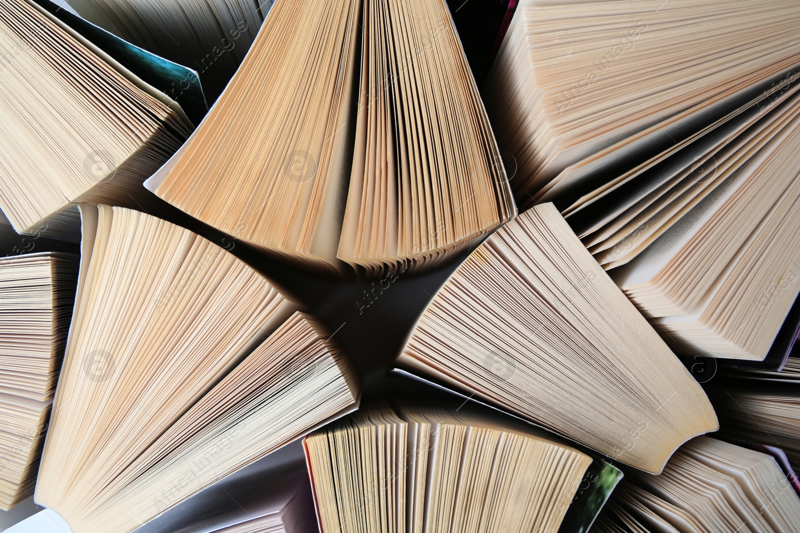 Photo of Collection of different books on white shelf, above view