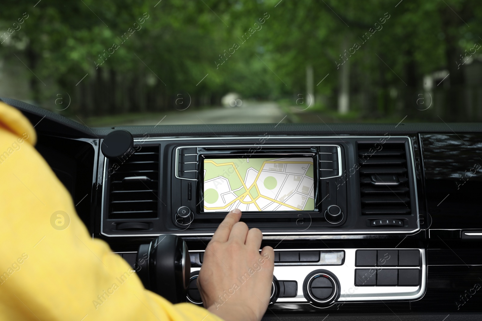 Image of Woman using navigation system while driving car, closeup