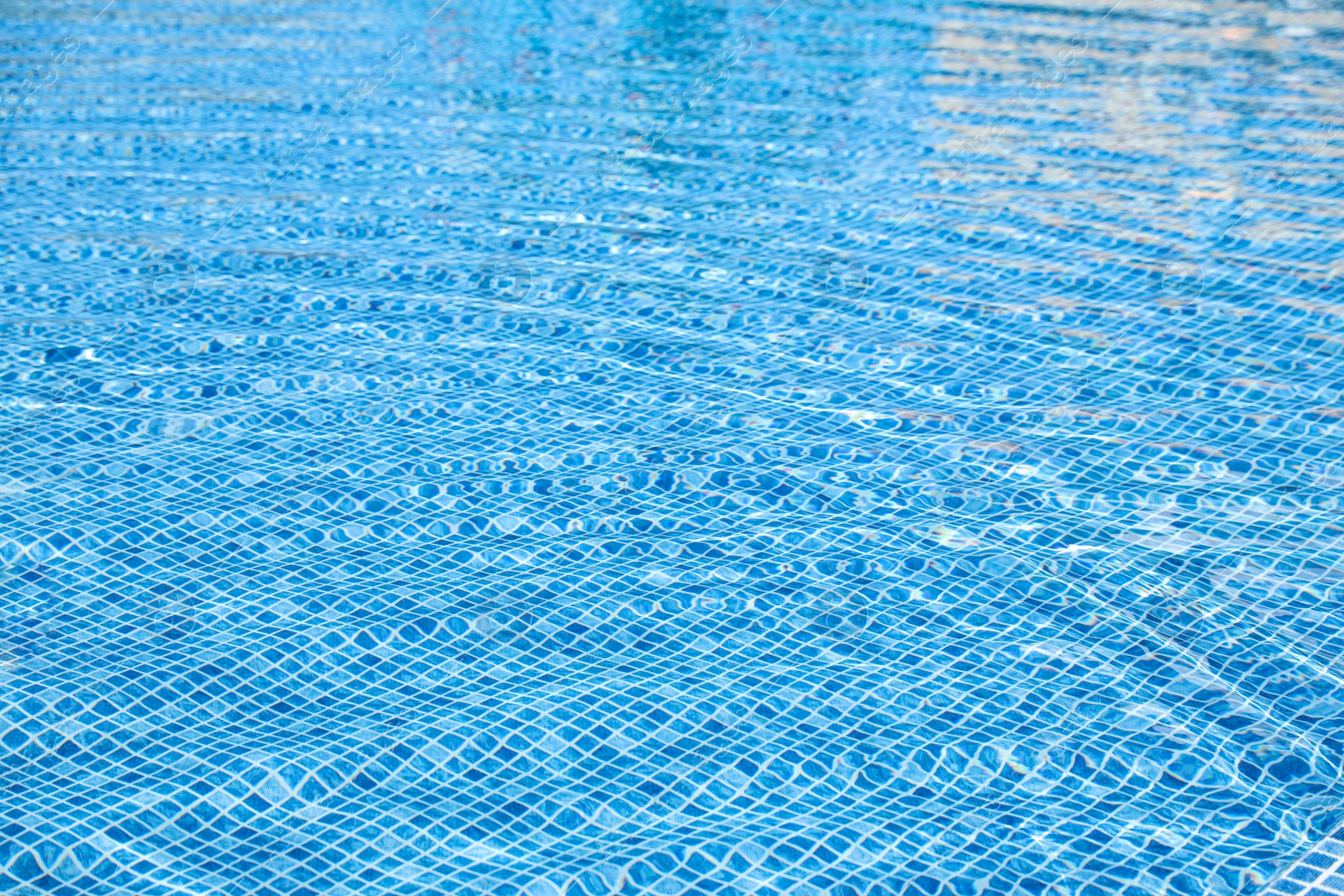 Photo of Swimming pool with clean blue water as background. Summer vacation