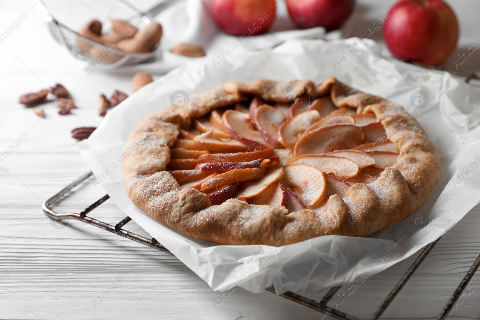 Photo of Delicious apple galette on white wooden table