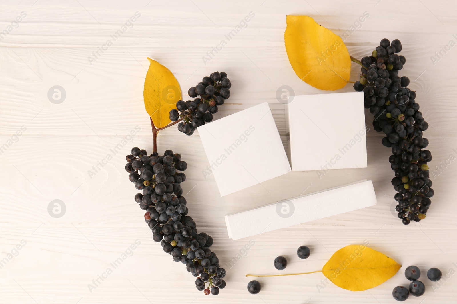 Photo of Thanksgiving day, holiday celebrated every fourth Thursday in November. Block calendar, yellow leaves and berries on white wooden table, flat lay and space for text