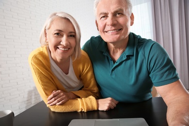 Photo of Mature couple using video chat at home, view from web camera