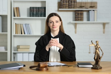 Portrait of judge in court dress at table indoors