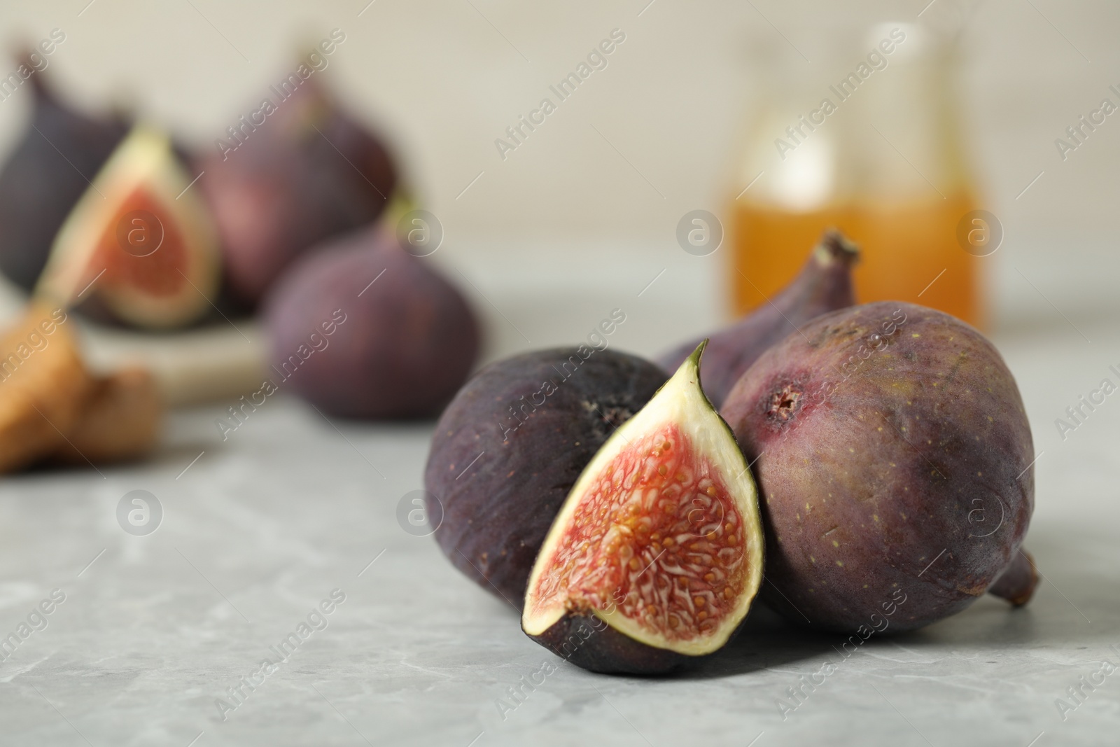 Photo of Tasty raw figs on light grey marble table, closeup