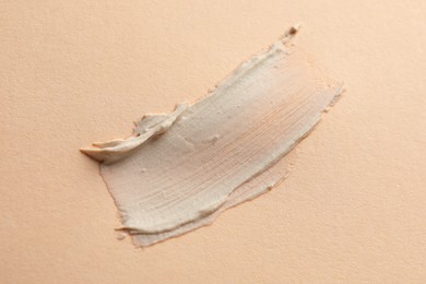 Sample of face mask on beige background, top view