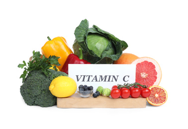 Photo of Paper note with phrase VITAMIN C and fresh products on white background