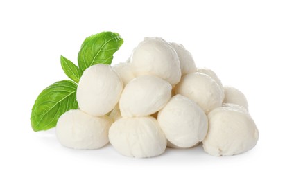 Photo of Pile of mozzarella cheese balls and basil on white background