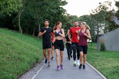Photo of Group of people running outdoors. Active lifestyle