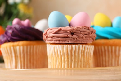 Tasty decorated Easter cupcakes on stand, closeup