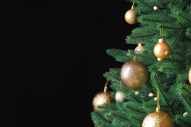 Photo of Beautiful Christmas tree with festive decor on black background. Space for text