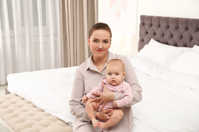 Young woman and her little baby at home