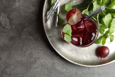 Photo of Delicious grape soda water with mint on grey table, top view. Refreshing drink