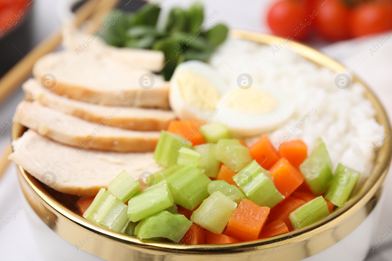 Photo of Delicious poke bowl with meat, egg, rice and vegetables, closeup