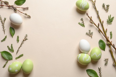 Flat lay composition with painted Easter eggs on color background, space for text