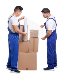 Photo of Workers wrapping boxes in stretch film on white background