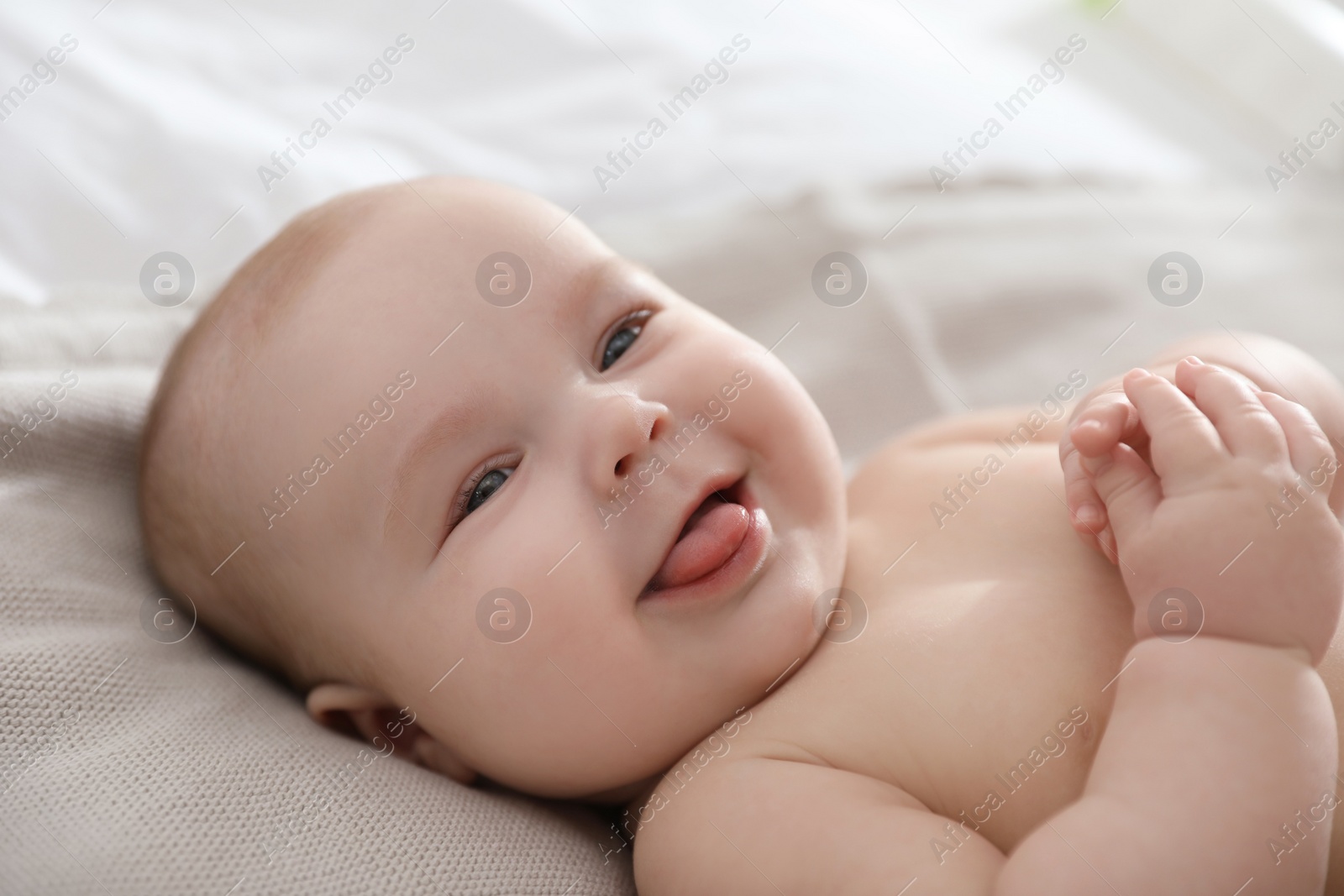 Photo of Cute little baby lying on bed, closeup